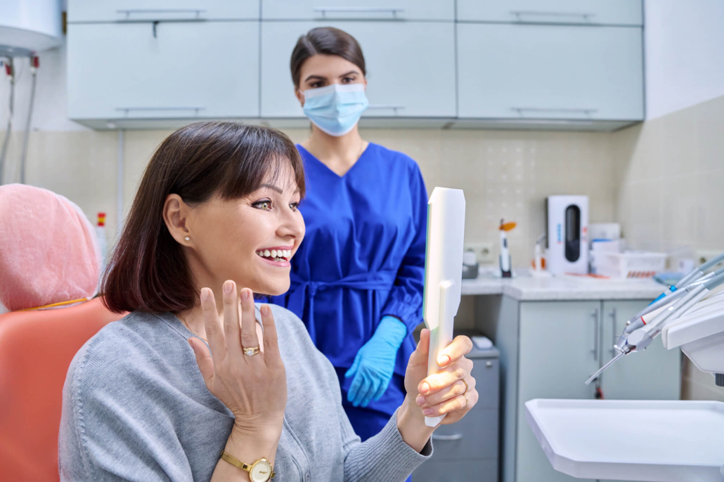 patient checking out her new hollywood dental implants