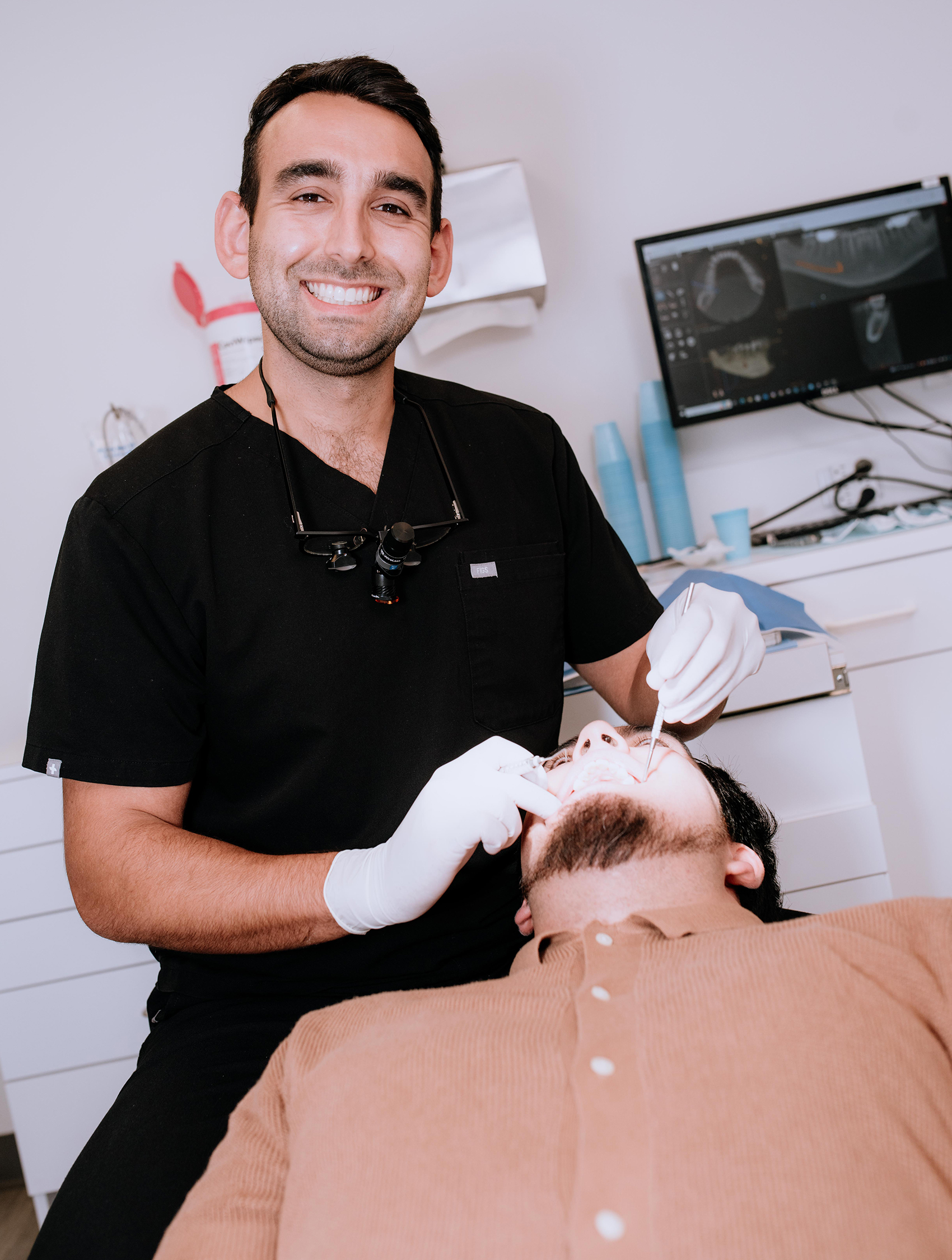 Dentist performing dental examination on patient in modern dental clinic